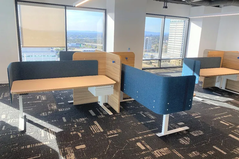 Collaborative benching with blue acoustic screens, software company, Glendale