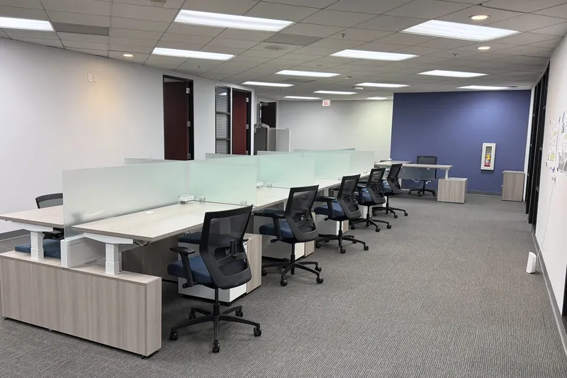 Sit-stand benching with frosted privacy screens, advisory firm office