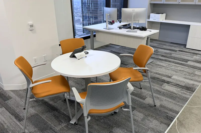Round touchdown table with orange chairs, nonprofit health organization, Los Angeles