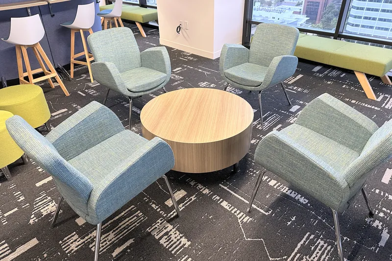 Lounge chairs around a round wood table, software company, Glendale