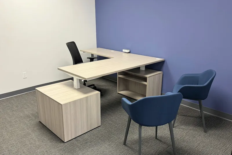 Private office with L-shaped height-adjustable desk, advisory firm office